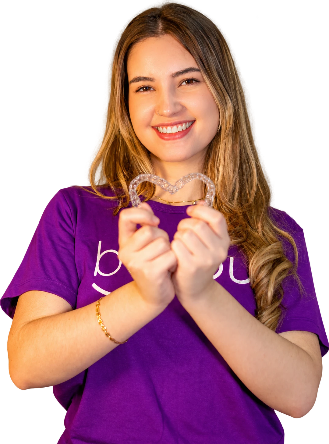 Mulher sorrindo com camiseta Beyou e segurando alinhadores em formato de coração